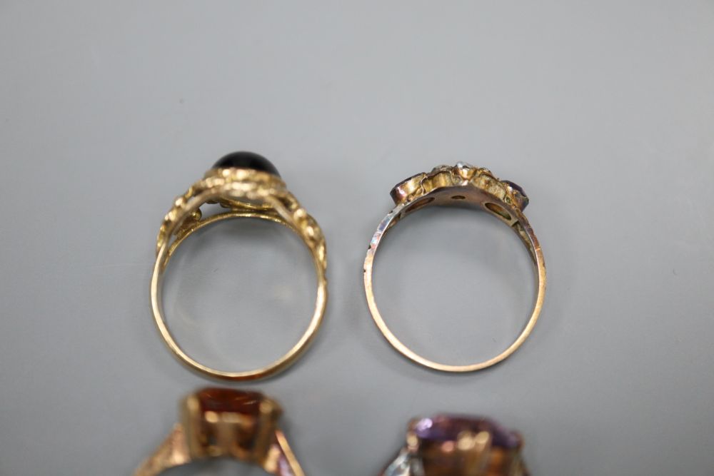 Four assorted early 20th century and later 9ct and gem set dress rings, gross 11.7 grams.